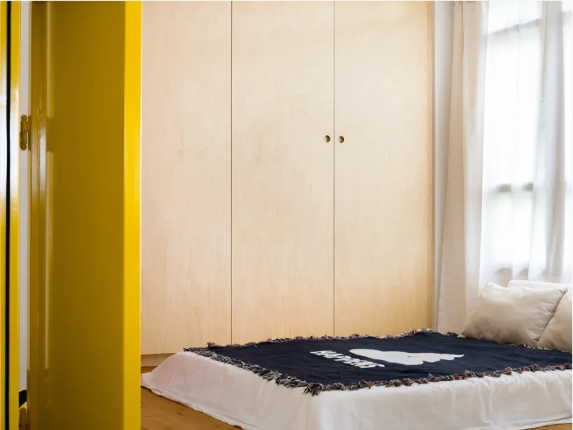 Bedroom with integrated light-toned wardrobe carpentry in a 3-Room BTO interior at Bidadari by Singapore Interior Designers The Local INN.terior