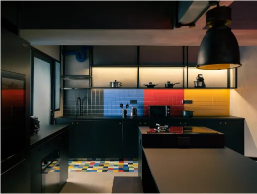 Kitchen with dark cabinetry and colour-block backsplash in a 5-Room BTO interior at Punggol by Singapore Interior Designers The Local INN.terior