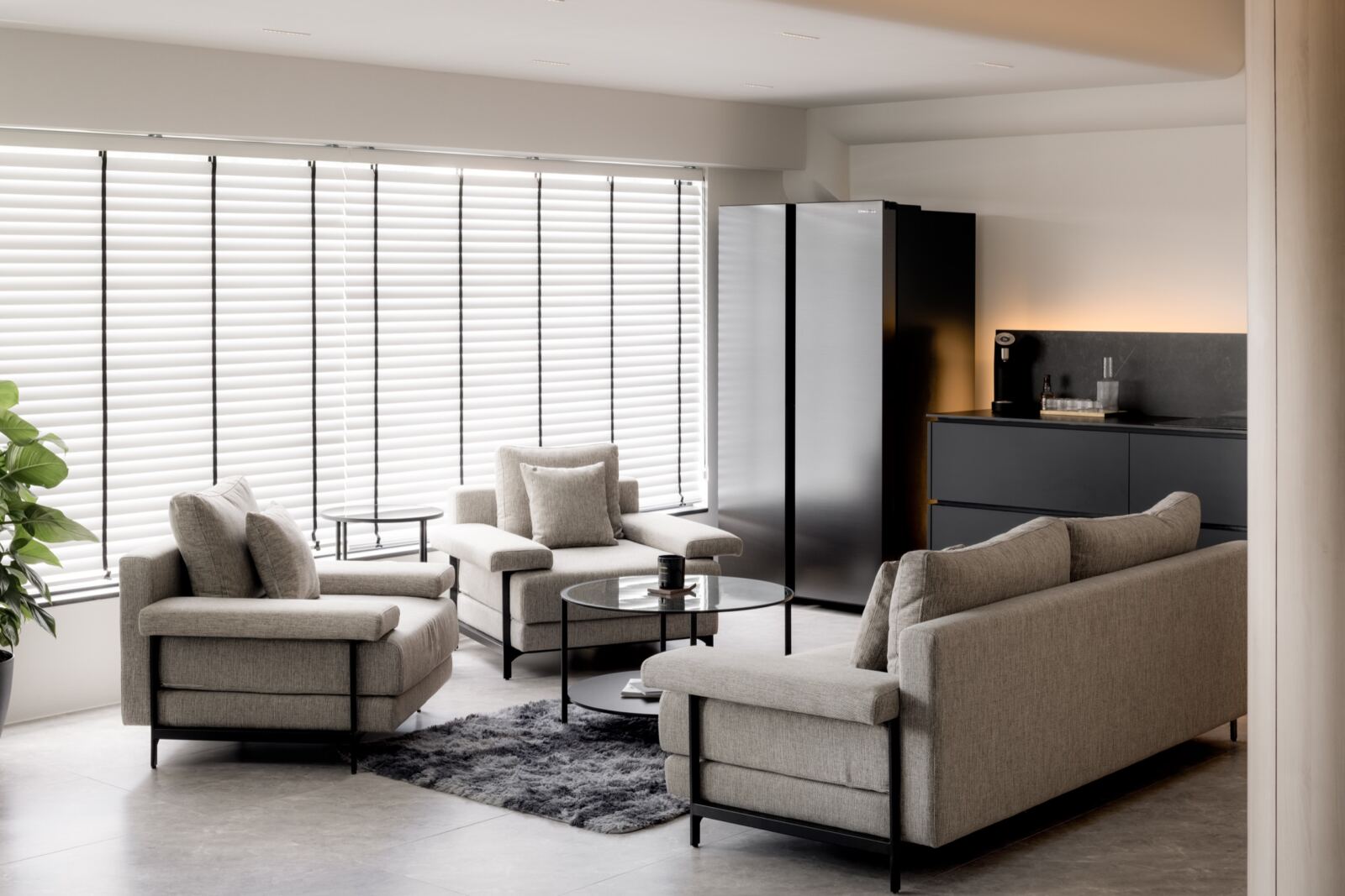 Gardens Showroom commercial lounge with full-height blinds, display cabinetry and soft seating by The Local INN.terior