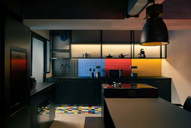 BTO Punggol 5-Room — kitchen with dark cabinetry and colour-block backsplash by The Local INN.terior